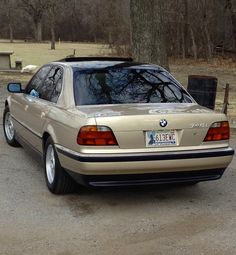 a beige car parked in a parking lot