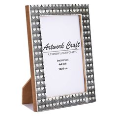 an antique style photo frame is shown in black and white with a brown leather backing