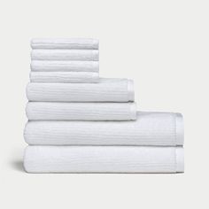 six white towels stacked on top of each other