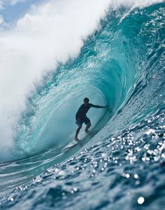 a man riding a wave on top of a surfboard