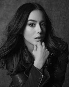 a black and white photo of a woman wearing a leather jacket