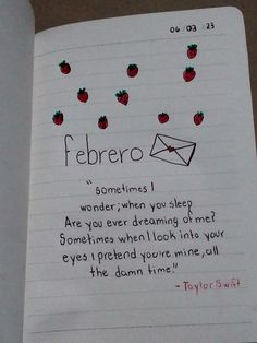 an open notebook with writing and strawberries on it