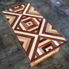 a wooden table with geometric designs on it