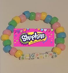 a candy bar bracelet with the word shopkinss spelled out in front of it