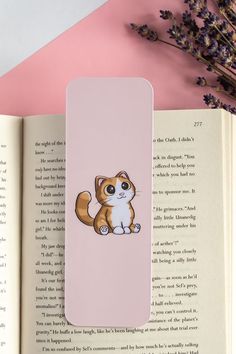 an open book with a cat sticker on it