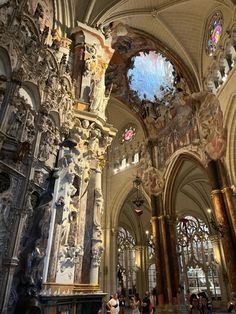 the inside of a church with people walking around