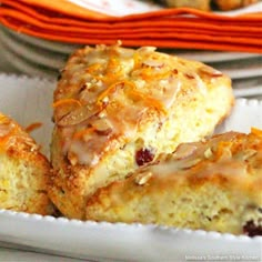 two pieces of cake sitting on top of a white plate next to orange napkins