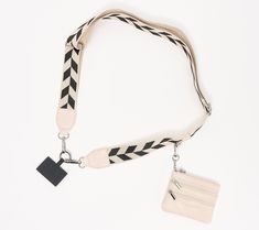 a black and white lanyard with a tag attached to it, on a white background