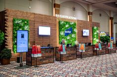 an exhibit booth at a convention with plants on the wall