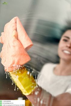 a woman holding up a yellow and orange towel