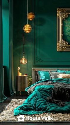 a bedroom with teal walls and green bedding in the center, gold framed artwork on the wall