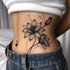 a woman with a flower tattoo on her stomach