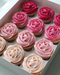 there are many cupcakes with pink frosting on the top and one has a rose