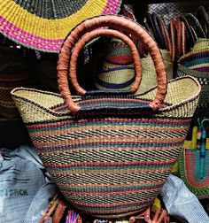 U-shopper basket is the perfect tote, beach bag, shopper, everyday bag, or home decor basket.  The beautiful bolga baskets are hand-woven in small villages of Ghana, a tradition passed down from generation to generation. They are woven out of renewable resource elephant grass, which grow abundantly in the region. Each basket is hand woven and 100% unique! The leather handle is treated using an all-natural process (either dyed and oiled or painted). Note that handle colors will vary and may range from black to an oiled red color.  Variations are to be expected and treasured. Baskets are sturdy, strong, and flexible. If properly cared for, your basket will live a long life. Details Large U-Shopper basket measures approx 16-18 inches across and 11-13" deep.   The basket is washable and collap Tote Beach Bag, Bolga Basket, Market Basket, Home Decor Baskets, Market Baskets, Everyday Bag, Leather Handle, Beach Bag, Ghana