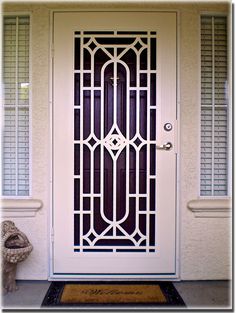 a white door with an iron screen on the front entrance to a home in florida