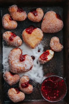 heart shaped pastries with jam and powdered sugar