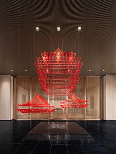 a large red sculpture in the middle of a room