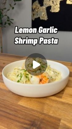 lemon garlic shrimp pasta in a white bowl on a wooden table with text overlay reading lemon garlic shrimp pasta