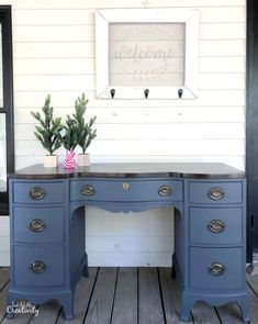 an old desk painted blue with white trim