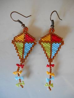 a pair of colorful beaded earrings hanging from hooks