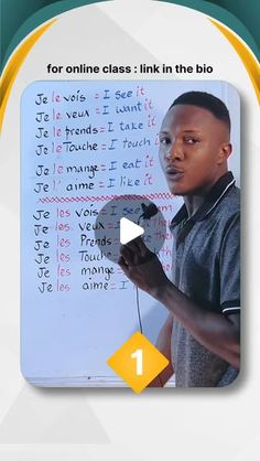 a young man holding a computer mouse in front of a white board with writing on it