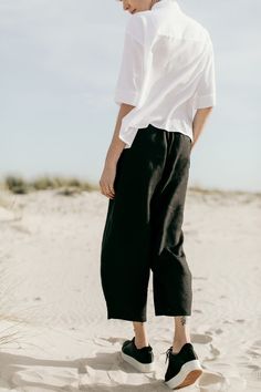 ZOZO - black linen culotte trousers. Wide legs getting narrower towards the bottom. There is a wide rubber band in the waist. Pockets in the side stitches. Color: black Fabric: 100% linen Wash in a washing machine in 30 degrees Celsius. To prevent the fabric from shrinking, first washing should be in 20 degrees Celsius The model (176 cm) is wearing the size M/L. Sizes: XS / S Waist: 70-90 cm  Hips: 110 cm Total length: 82 cm Leg width (bottom): 43 cm M / L  Waist: 80-95 cm  Hips: 114 cm Total length: 86 cm Leg width (bottom): 45 cm Black Linen Summer Bottoms, Black Linen Bottoms For Summer, Black Linen Harem Pants For Spring, Black Linen Wide-leg Pants, Black Linen Wide Leg Bottoms, Black Linen Wide Leg Pants With Elastic Waistband, Black Wide Leg Culottes For Summer, Black Wide Leg Summer Culottes, Black Linen Harem Pants For Summer