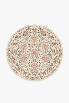 a round rug with an intricate design on the center and sides, in white background