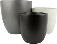 three black and white vases sitting next to each other