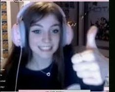 a girl with headphones giving the thumbs up sign