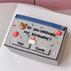 a birthday cake that is shaped to look like a computer screen with the message do you celebrate my birthday? yes sure