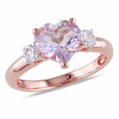 Indulge in romance with this enchanting 1.95 ct. t.g.w. Rose de France and Created White Sapphire Heart Ring in Rose Plated Sterling Silver. The focal point of the ring is a stunning heart-shaped Rose de France gemstone, radiating soft pink hues and elegance. Surrounding the centerpiece are shimmering created white sapphires, adding brilliance and sophistication to the design. Crafted with precision and finished with rose plated sterling silver, this ring is a timeless and romantic addition to any jewelry collection, perfect for expressing love and affection. | Belk & Co Lab Created Rose de France and Created White Sapphire Heart Ring in Rose Plated Sterling Silver, Pink, 9 Heart Shaped Ring, Heart Engagement, White Sapphire Engagement Ring, Heart Engagement Rings, Silver Heart Ring, White Sapphire Ring, Pretty Rings, Calla Lily, 2 Carat