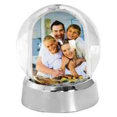 a snow globe with a family photo inside