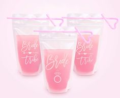 three plastic cups with straws in them and the words bride tribe printed on them