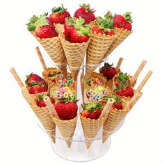 several cones with strawberries in them on a white background