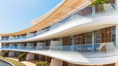 an architecturally designed building with balconies on the top floor