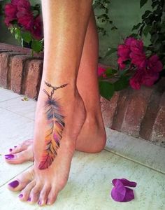 a woman's foot with an arrow tattoo on it