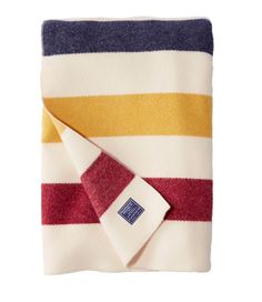 a striped towel folded on top of a white table with a red, yellow and blue stripe