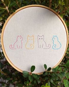 a cross stitch pattern with three cats on it