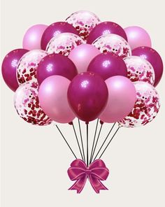 a bunch of pink and white balloons with a bow