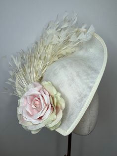 This beautiful large cream teadrop Sinamay fascinator features a pink rose and a beautiful array of cream feathers and sits on a cream satin aliceband.  This Fascinator is stunning, perfect for all summer events, weddings and races. Brand New. If you need your item by a certain date please let me know. Made in the UK. All items are handmade and may differ very slightly to picture shown.  Custom orders are welcome. Many more items are available in our Shop. Returns Please notify us within 3 days of receiving your item if you intend to return it. We allow 7 days from the date of receipt of the headpiece to return it to us, our returns requirements are that it is returned properly packaged to prevent damage in the post, it is unworn/as new condition and has not had the tag tampered with in an Royal Clothes, Sinamay Fascinator, Occasion Hats, Gold Feathers, Doll Hat, Ag Dolls, Wedding Hats, Summer Events, Rose Wedding