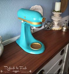 a blue mixer sitting on top of a wooden counter