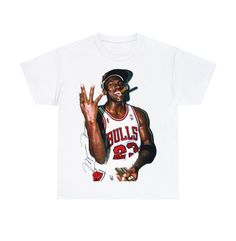 Michael Jordan Shirt | Rare Exclusive NBA Championship Tee | Vintage Chicago Bulls Jordan Rap Tee | The Last Dance 90s Style Face Tee | NBA The unisex heavy cotton tee is the basic staple of any wardrobe. It is the foundation upon which casual fashion grows. All it needs is a personalized design to elevate things to profitability. The specially spun fibers provide a smooth surface for premium printing vividity and sharpness. No side seams mean there are no itchy interruptions under the arms. The Jordan Year Birthday Shirts, Jordan Tshirt Nike, Jordan Year Birthday 23 Tshirt, Jordan 23 Class Shirts, Jordan Tops, Bootleg Design, Vintage Chicago Bulls, Nba Championship, Jordan Shirt