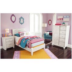 a bedroom with purple walls, white furniture and colorful rugs on the hardwood floor