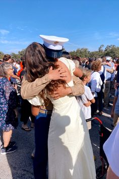 two women hugging each other in front of a crowd