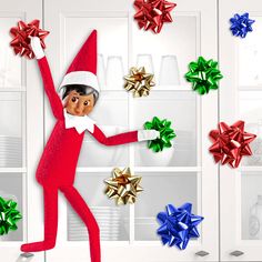 an elf is standing in front of christmas presents