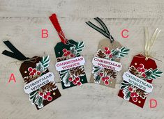 four tags with christmas wishes hanging from them on a wooden surface, labeled in red and green