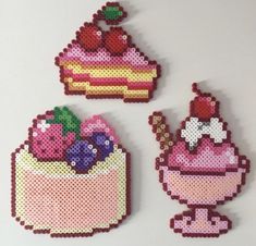 three pieces of bead art on a white surface