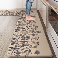 a woman standing on a mat in the kitchen