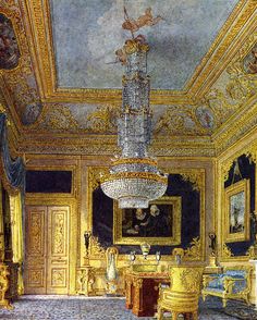 an ornately decorated room with chandelier and paintings