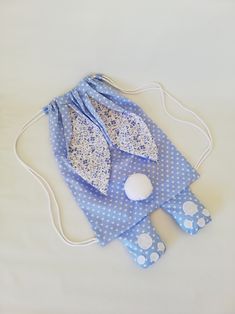 a blue and white polka dot cloth bag with an egg on it's side